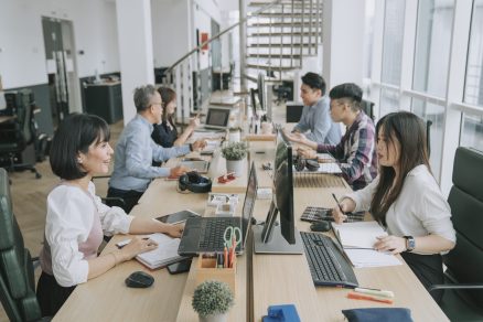Employees communicating at their desks 1536 x 1067