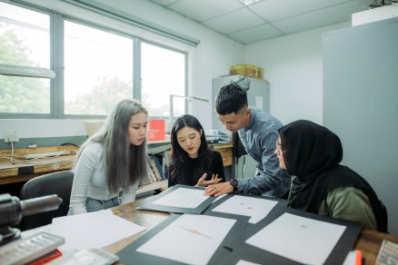 small group of students having discussion during jewelry class