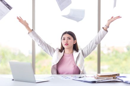 success young female manager, business woman throw working document on in office with view of computer laptop and graph document in concept of bored, success and business
